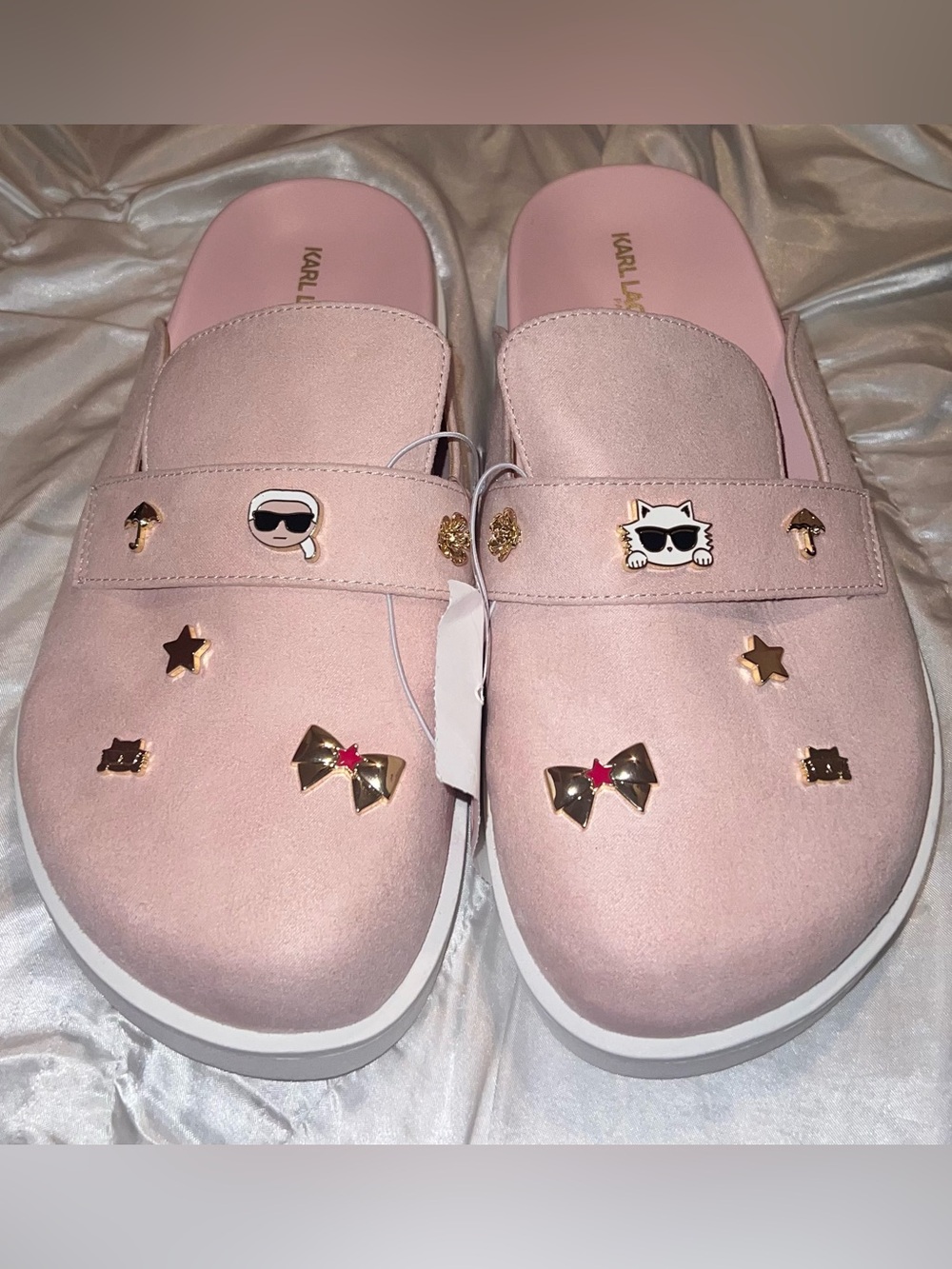 pink Karl Lagerfeld clogs featuring decorative charms